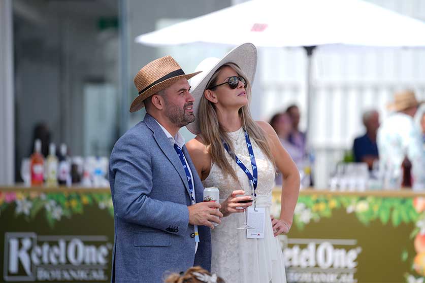 Couple watching races at Queen's Plate 2022 at Woodbine Racetrack