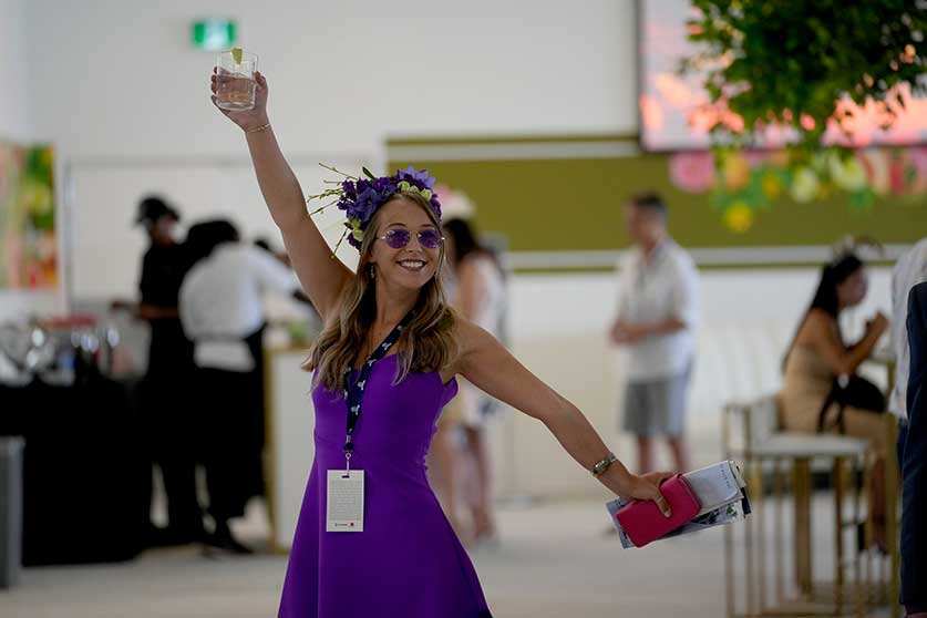 A lady in purple at Queen's Plate 2022 at Woodbine Racetrack