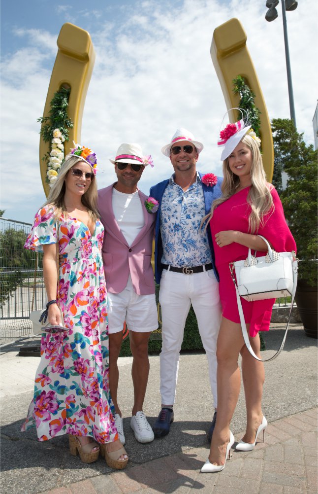 Two couples posing for a photo at the 164th King's Plate at Woodbine Racetrack.