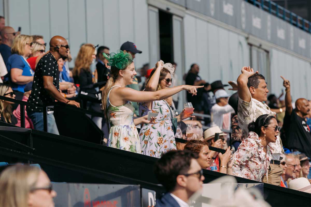 Spectators watching the winning horse at the King's Plate at Woodbine Racetrack.