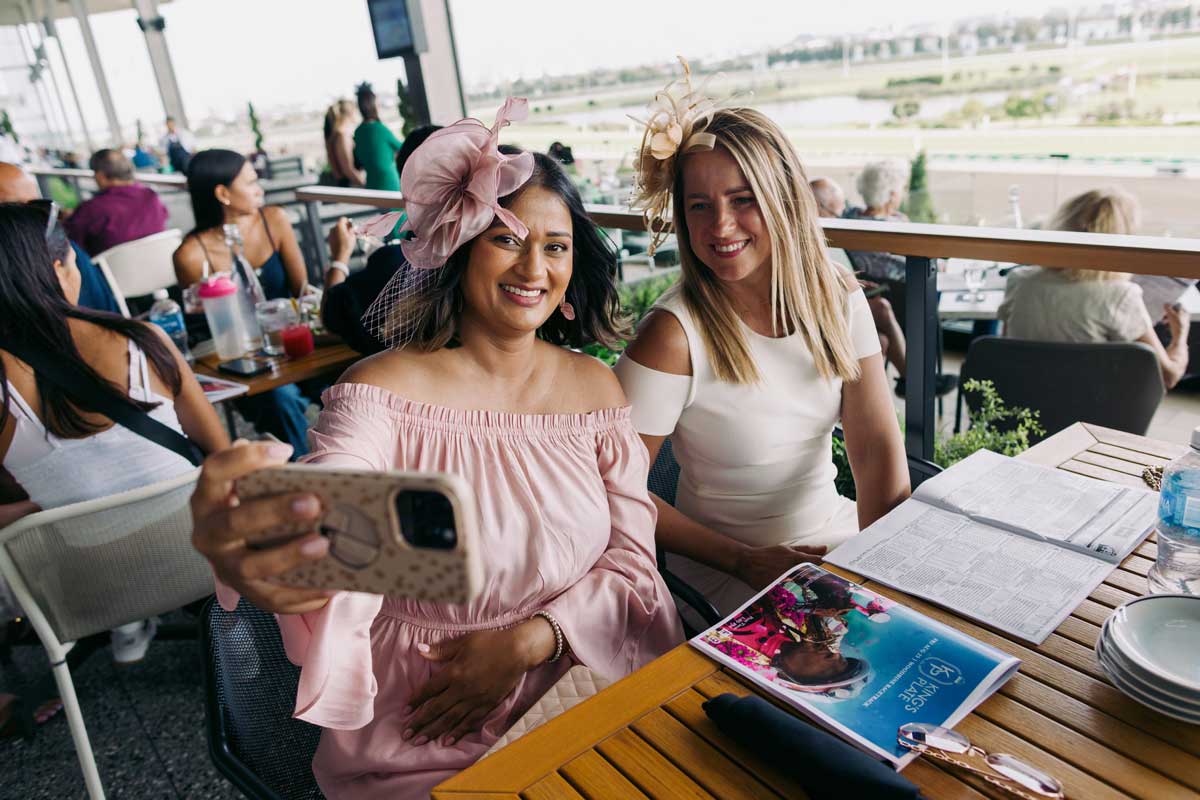 Guests taking selfie at Stella Artois Terrace during King's Plate at Woodbine Racetrack.