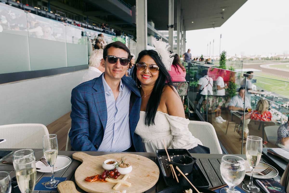 A couple posing for a photo at Stella Artois Terrace during King's Plate at Woodbine Racetrack.