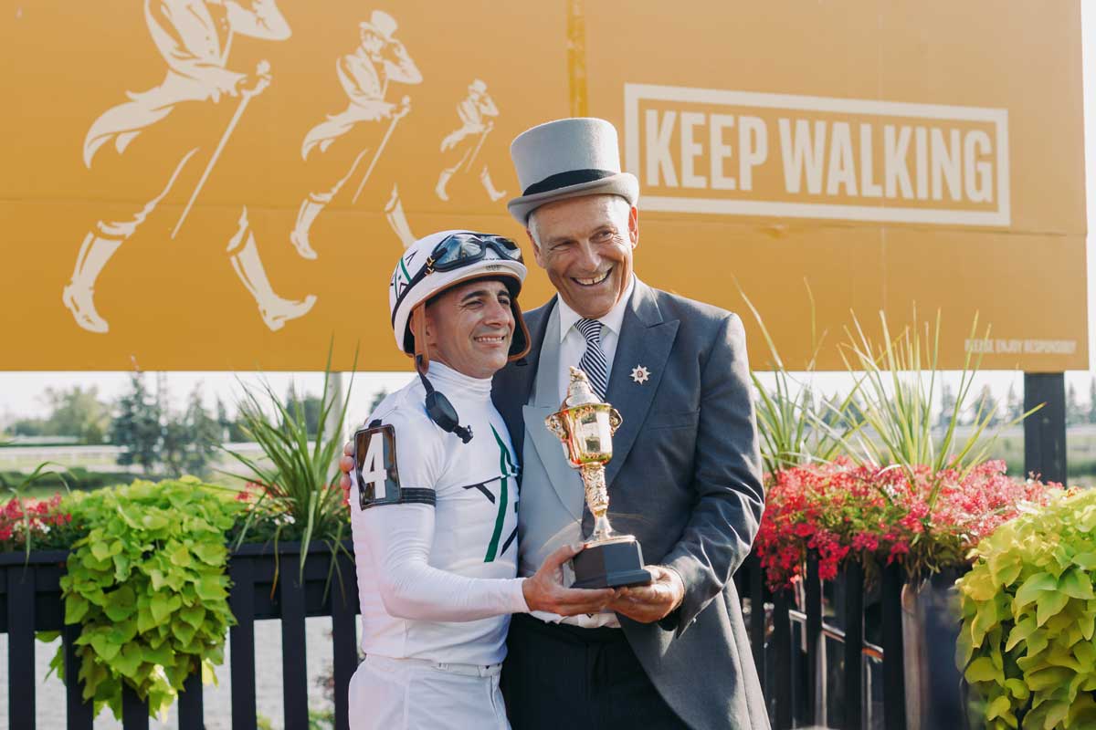 Jim Lawson, Chairman Woodbine Entertainment with the King's Plate winning Jockey Rafael Manuel Hernandez, presenting the trophy.