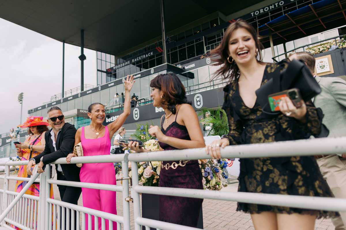 Enjoying the winning moments at the rails during King's Plate at Woodbine racetrack.