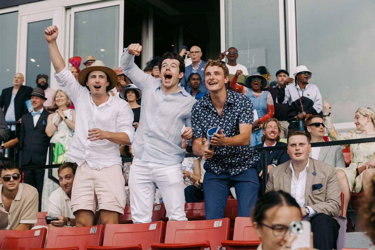 Guests cheering horses from Grandstand during King's Plate at Woodbine Racetrack.