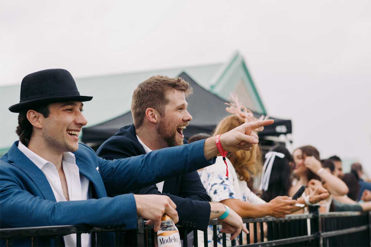 Guests watching races at the Trackside Clubhouse during King's Plate at Woodbine Racetrack.