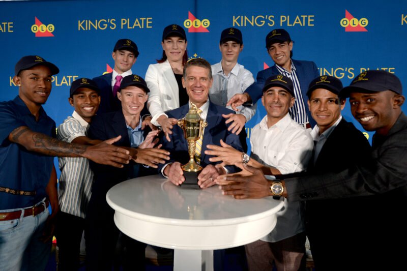 Toronto ON August 11, 2026..Woodbine Racetrack.167th Running Of $1,000,000 Dollar King's Plate Post Position Draw. (L R) Front Row Jockey's Xarel Forde (Bond Market)Romero Maragh(Very Special),Ryan Munger(Bachetto),Michael Copeland (Woodbine CEO), Rafael Hernandez(Highwaytothemoon),Jose Campos (Magical Factor)Jason Samuel(Fire And Wine)Back Row (L R)Fraser Aebly(Military Time),Emma Jayne Wilson( Don Ique),Pietro Moran (Dixie Law), Louis Contreras (Imyourmedicineman). Woodbine/ Michael Burns Photo