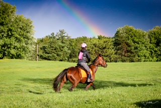 Westie finds his pot of gold with Sarah Cuthbertson, enjoying a ride under a rainbow. (supplied) 