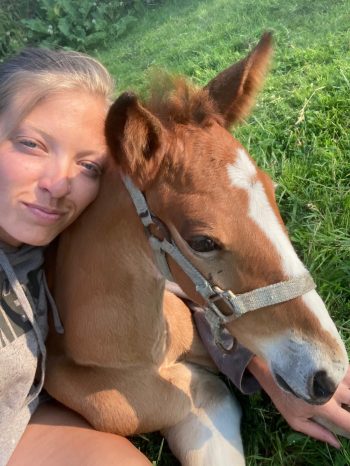 It’s all about the cuddles for Michelle Olson and foal “Roman”, the latest addition to the growing Olson empire. (Supplied) 