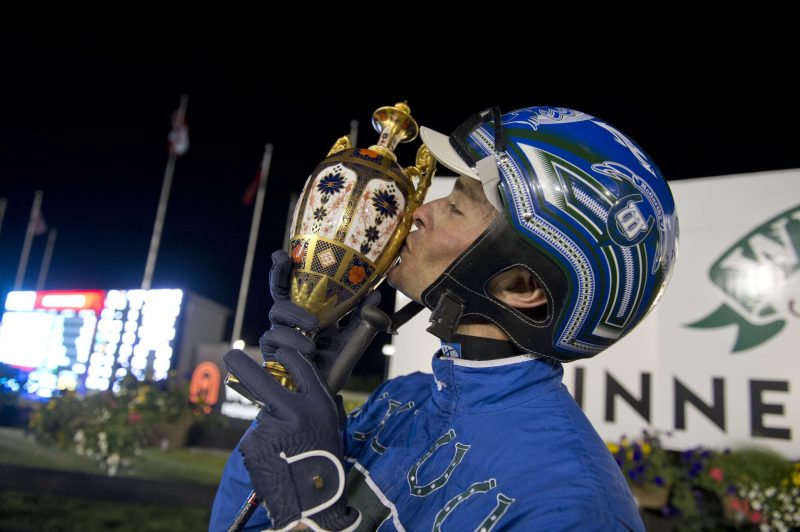 Winning driver Todd McCarthy kisses the Pepsi North America Cup trophy. 