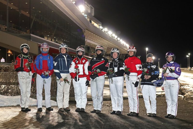 The field of drivers for March 7 International Women's Day race pose in front of the grandstand.