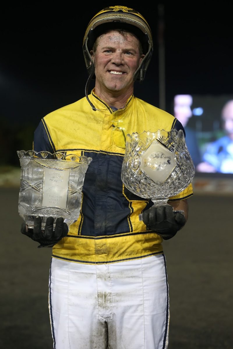 Randy Waples poses with the Metro Pace and Canadian Pacing Derby trophies after winning both races in 2015. (New Image Media)