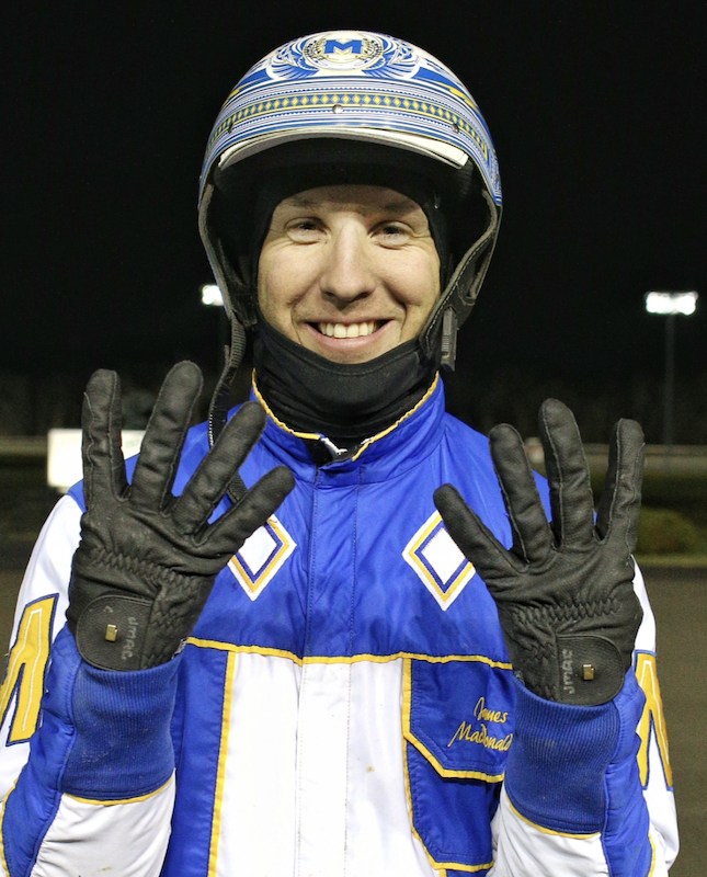 James MacDonald holds up eight fingers after winning a single-night record eight races on Monday at Woodbine Mohawk Park. 