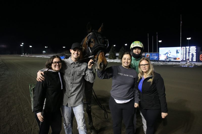 Travis Forbes trainee Assassins Creed and connections in the Woodbine Mohawk Park winner's circle on March 6, 2023 (New Image Media) 