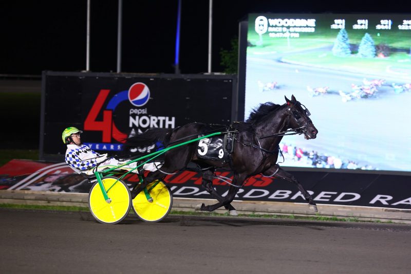Confederate and driver Tim Tetrick winning the fourth Pepsi North America Cup Elimination on June 10, 2023 at Woodbine Mohawk Park (New Image Media)