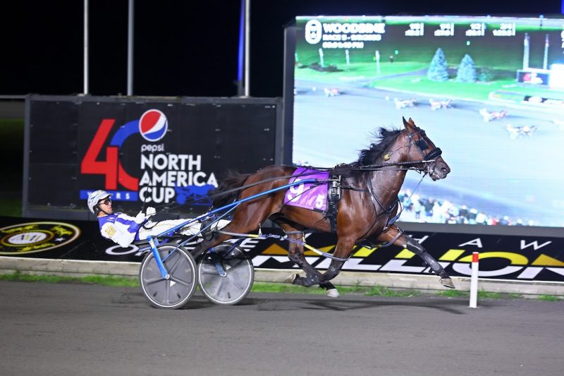 Legendary Hanover and driver James MacDonald winning the first Champlain division on September 9, 2023 at Woodbine Mohawk Park (New Image Media)