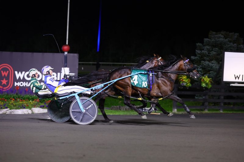 Tattoo Artist and driver Louis-Philippe Roy winning the 2023 Canadian Pacing Derby at Woodbine Mohawk Park (New Image Media)