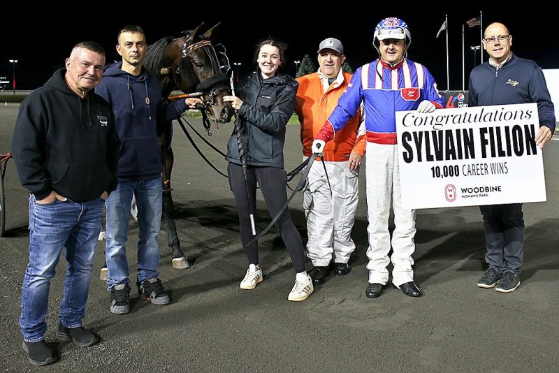 Sylvain Filion is congratulated by Bill McLinchey, Vice-President of Standardbred Racing, following his major milestone victory.