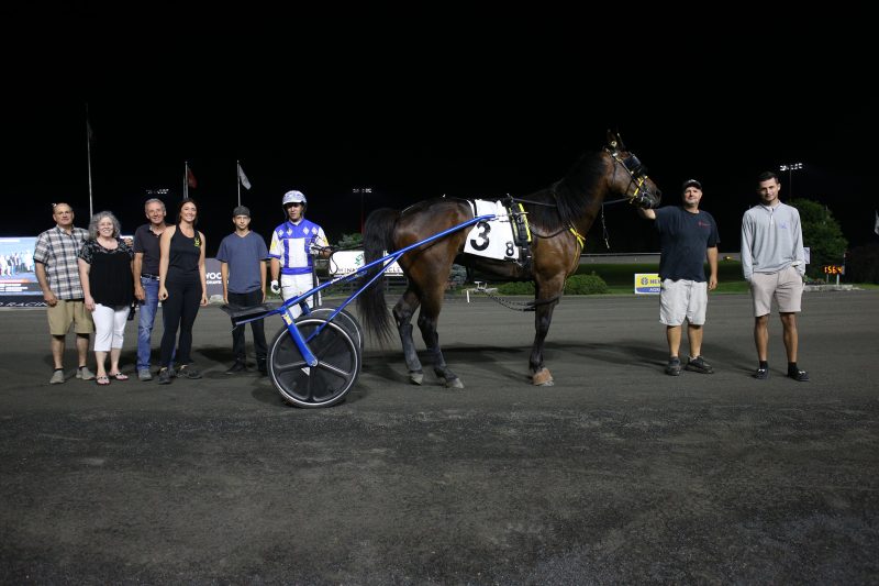 Top Mast, Desiree Jones, and connections in the Woodbine Mohawk Park winner's circle on August 3, 2023 (New Image Media)