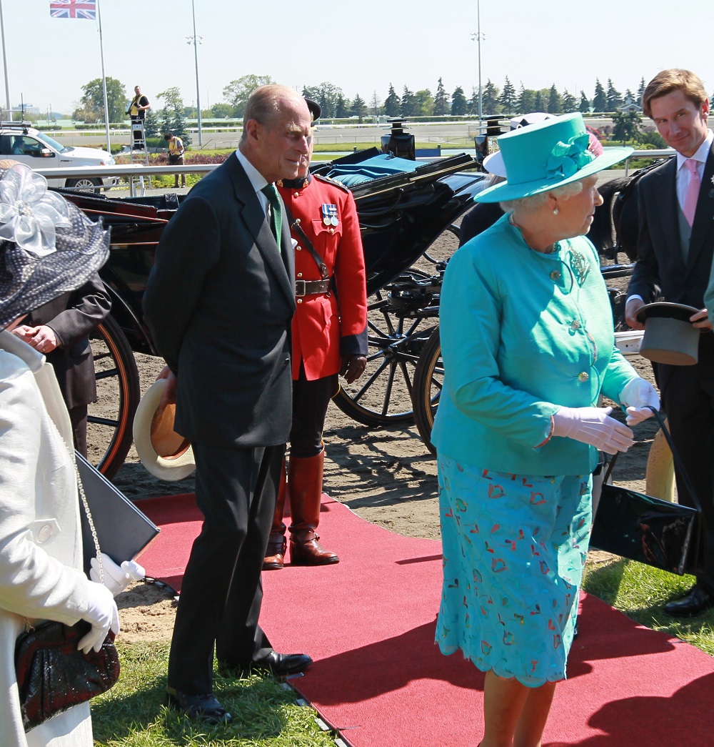 Queen Elizabeth II with her husband Prince Philip on a red carpet at Woodbine Racetrack on her visit for Queens Plate