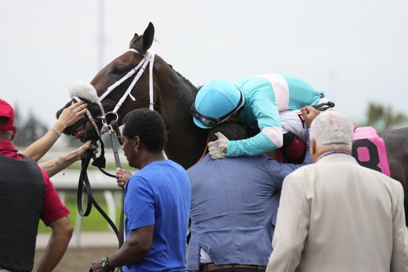 Moira, Rafael Herandez and Kevin Attard embrace after winning the Queen's Plate on August 21, 2022 at Woodbine (Michael Buns Photo)