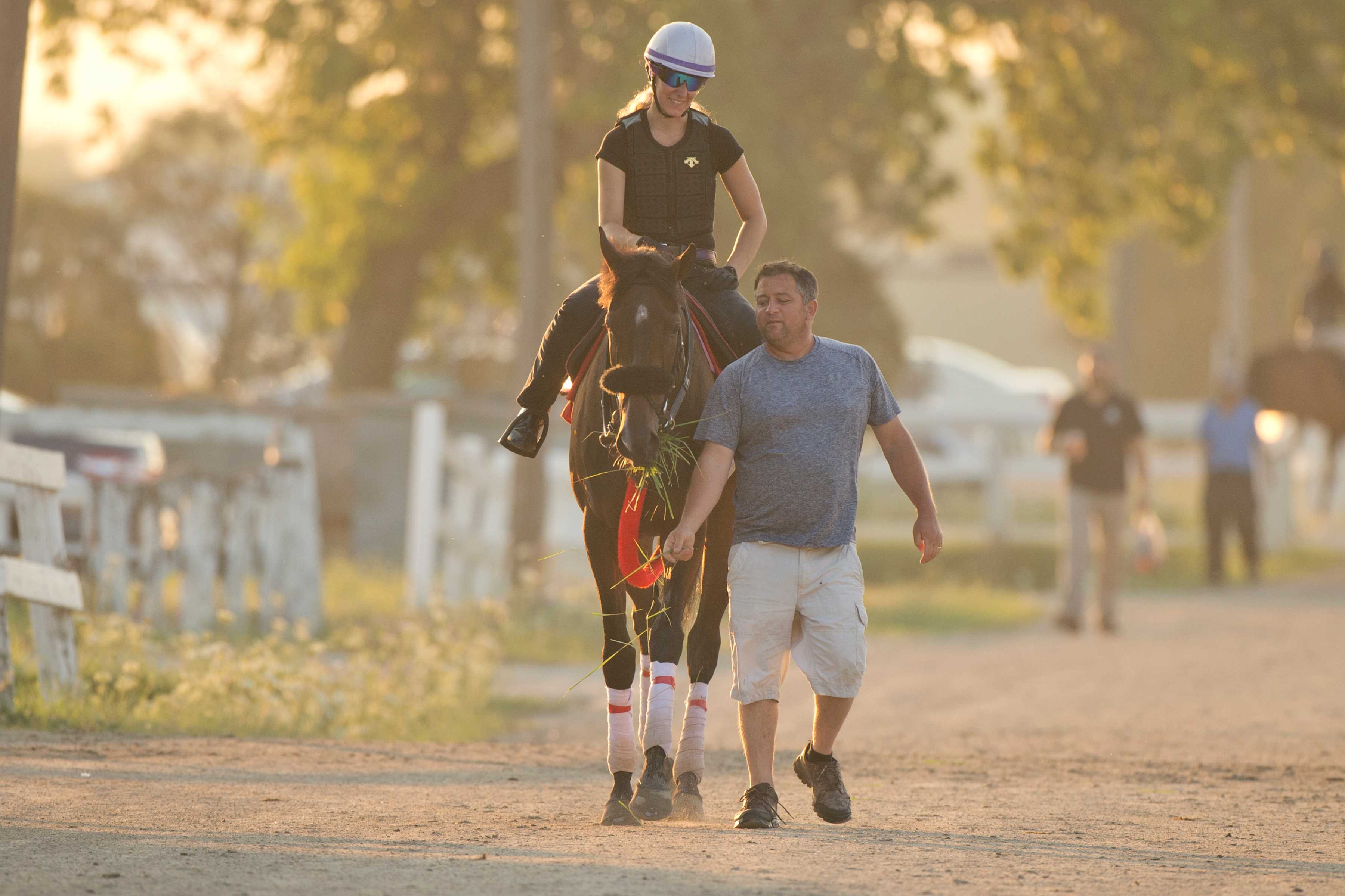 Kevin Attard walks Moira while on the Woodbine Backstretch in 2022 (Michael Burns Photo)