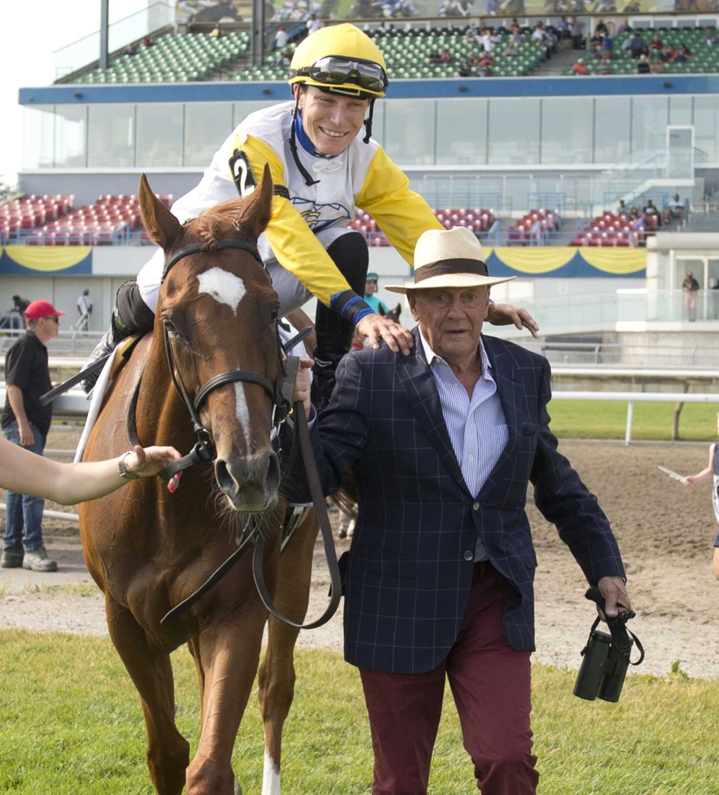 Emma-Jayne Wilson embracing trainer Roger Attfield on the way to the winners circle after winning the 2022 Nassau Stakes (G2) with Lady Shakespeare (Michael Burns Photo)