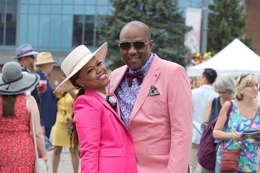 A couple in pink posing at the Queen's Plate at Woodbine Racetrack