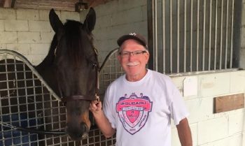 Nicholas Gonzalez poses with his stable standout, Silent Poet, in the Woodbine backstretch. (Supplied)