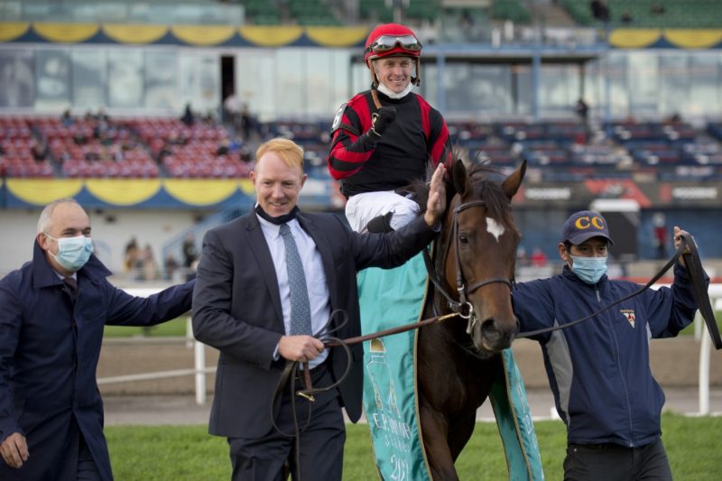 The connections of Mutamakina (GB) and jockey Dylan Davis celebrate winning the Grade 1 E. P. Taylor Stakes at Woodbine. (Michael Burns Photo)
