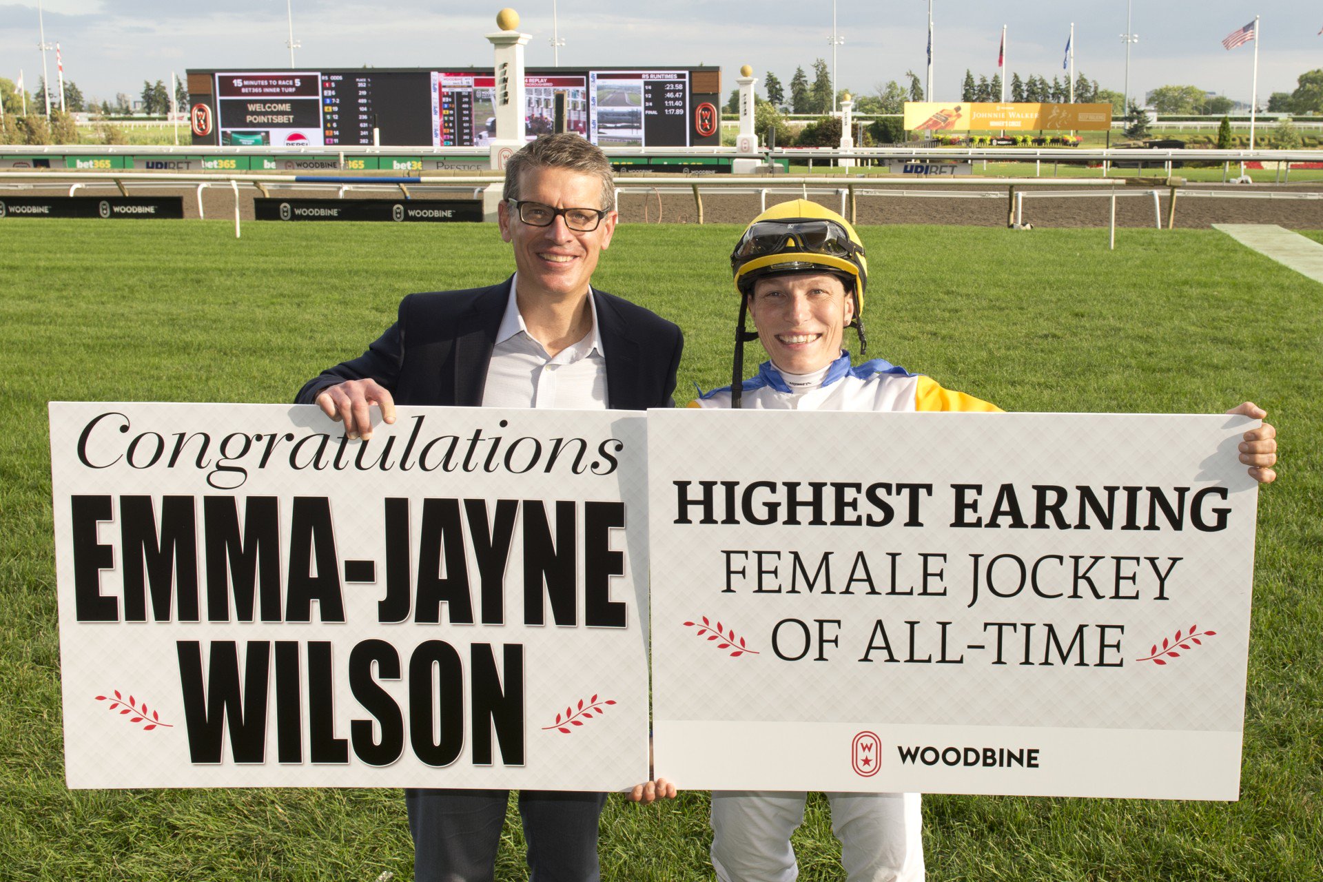 Michael Copeland, CEO of Woodbine Entertainment, congratulates Emma-Jayne Wilson on becoming the highest earning female jockey of all-time. (Michael Burns Photo)