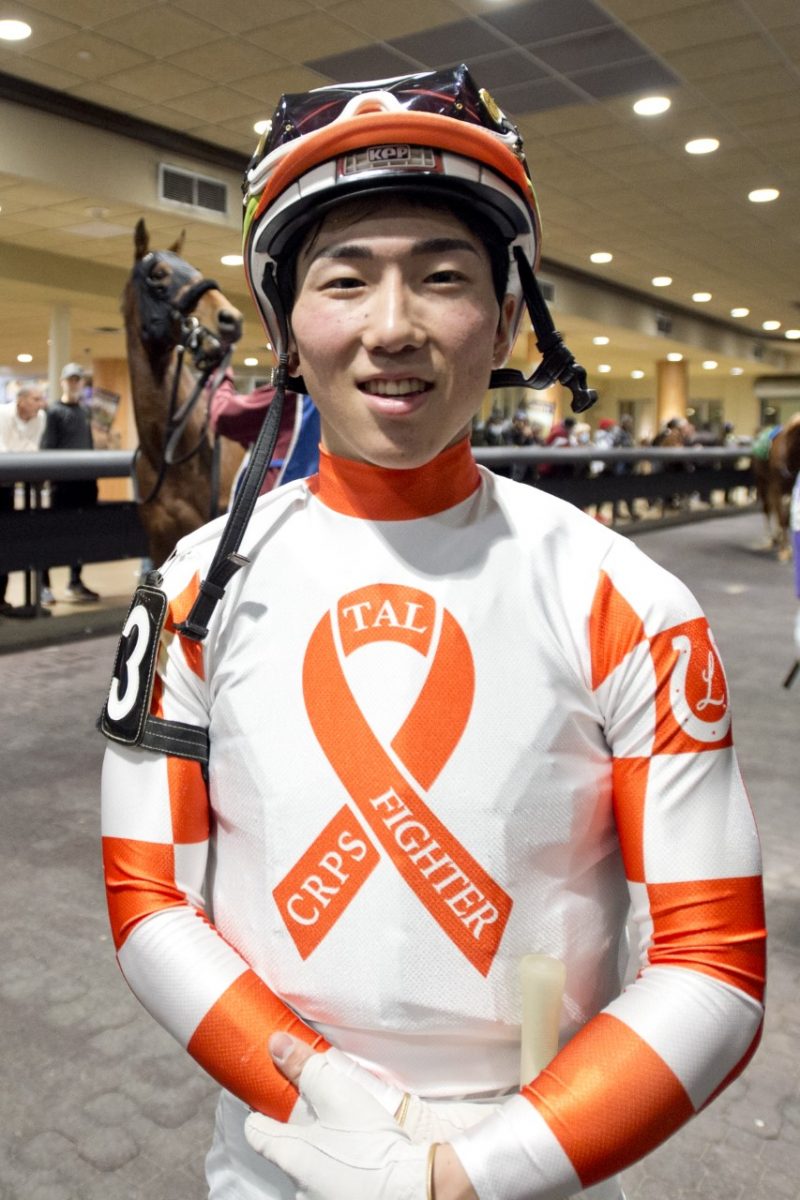 Kazushi Kimura wearing TEC Racing's orange silks to spread awareness for complex regional pain syndrome (CRPS). (Michael Burns Photo)